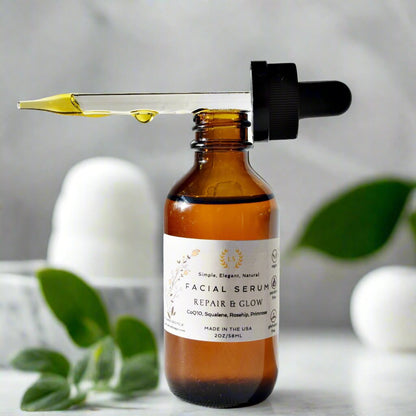 facial serum in 2oz bottle with dropper out of the bottle, with argan oil, coQ0, Rosehip oil and botanical extracts